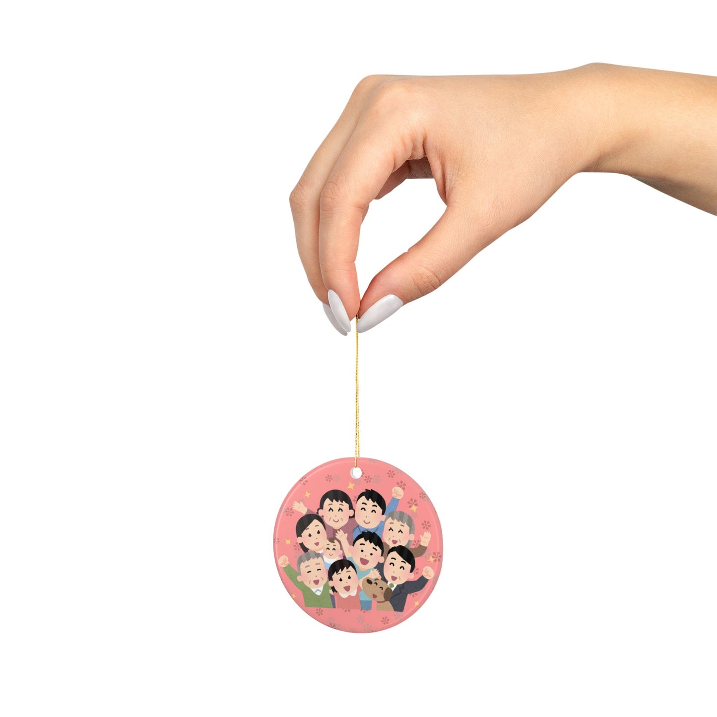 Round red ornament with cartoon characters family held by a hand on a white background