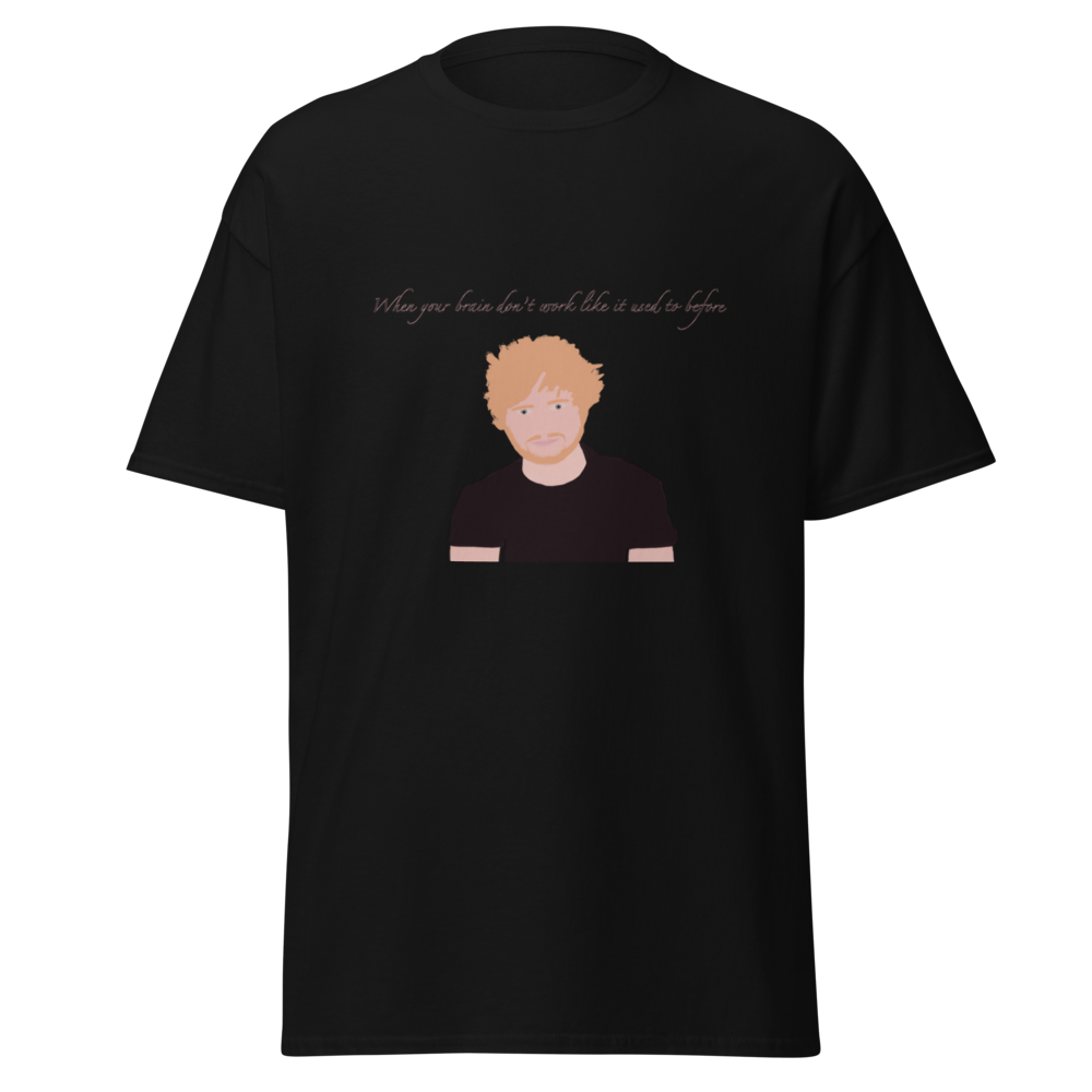 A black short-sleeve crewneck t-shirt featuring a graphic print of a stylized cartoon illustration of a man with orange hair and a beard, with the text 'When your brain doesn't work like it should and it does' printed above.