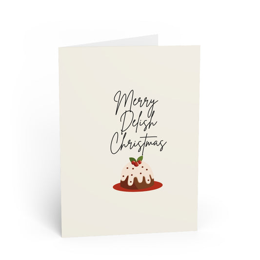 Greeting card with a Christmas pudding illustration and 'Merry Delish Christmas' text on a white background.