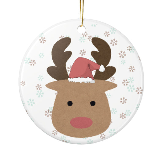 Christmas ornament with a reindeer wearing a Santa hat on a white, snowflakes background