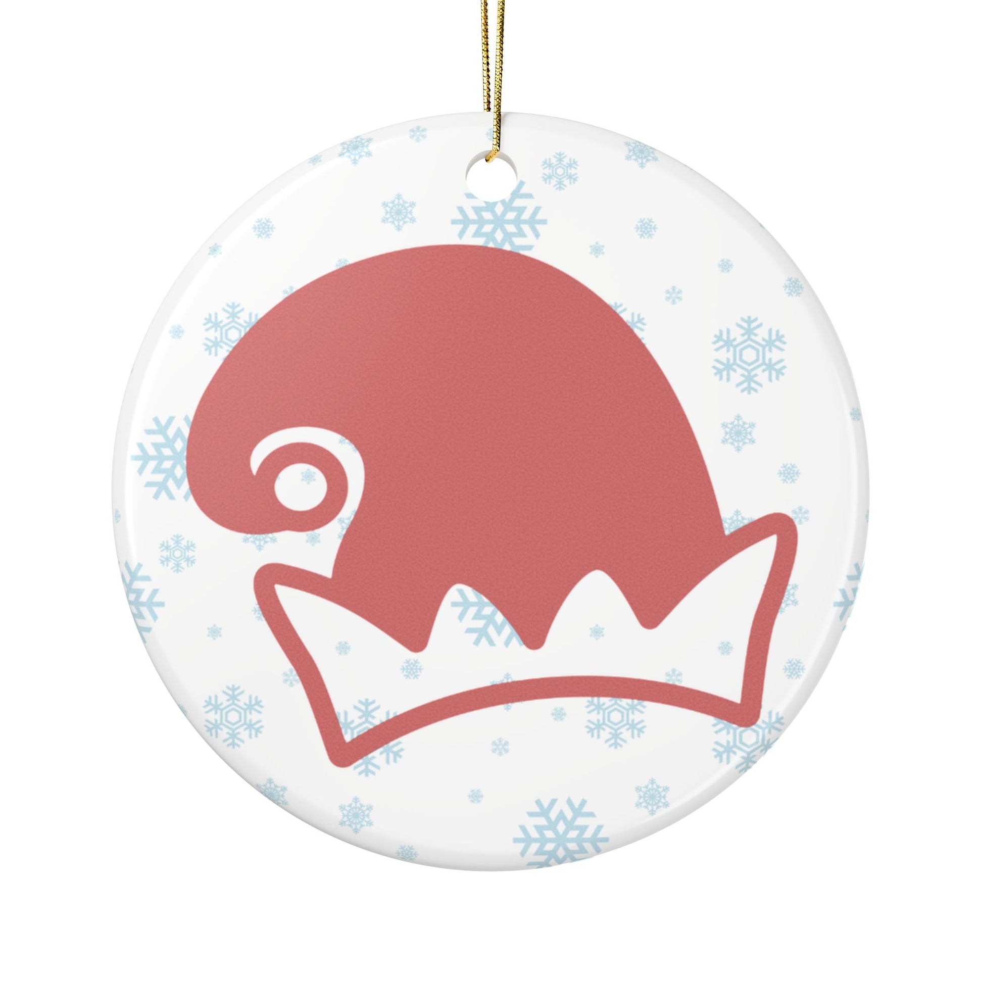 Round ceramic ornament with a red elf hat design on a white background with blue snowflakes.
