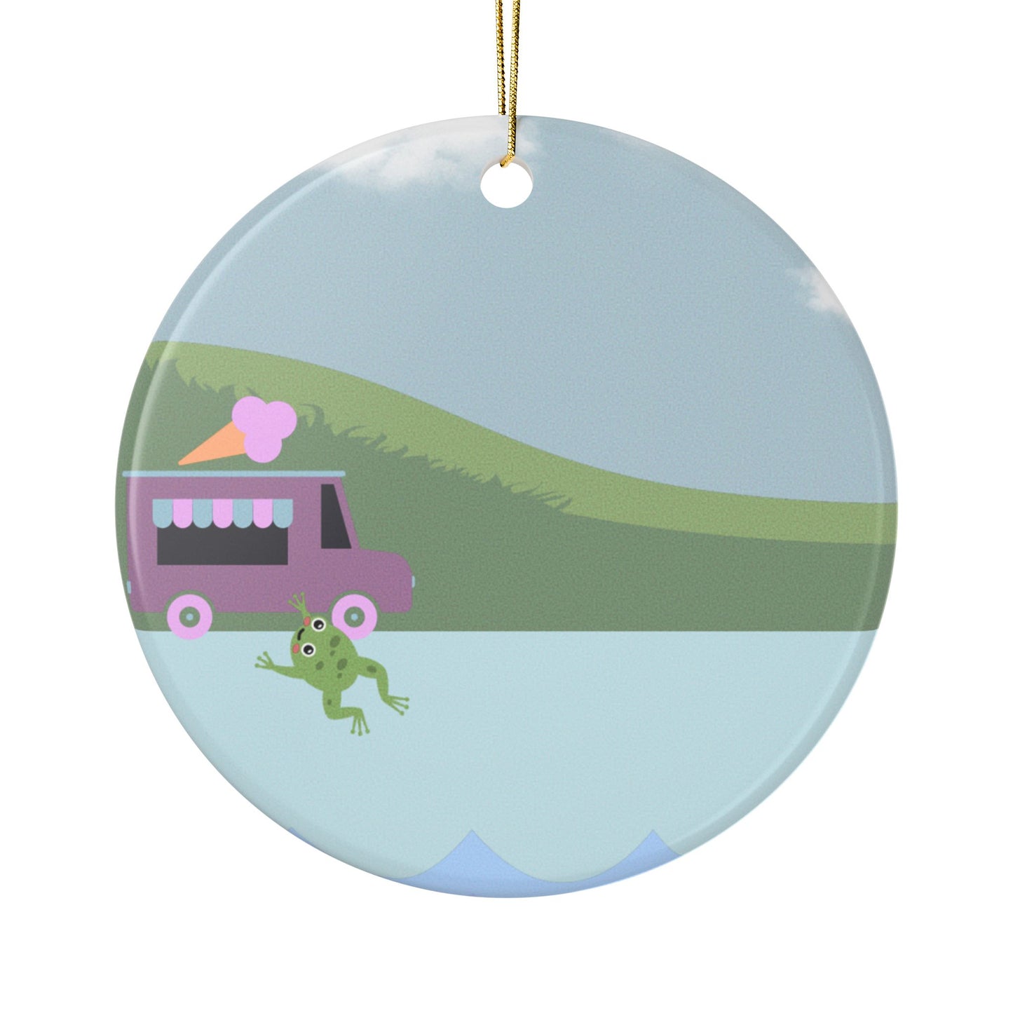 Round ceramic ornament with a frog, ice cream truck, and landscape design on a light blue background.