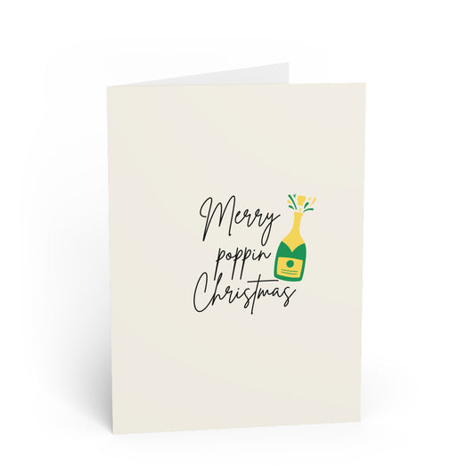 Greeting card with 'Merry poppin Christmas' text and champagne bottle illustration on a white background