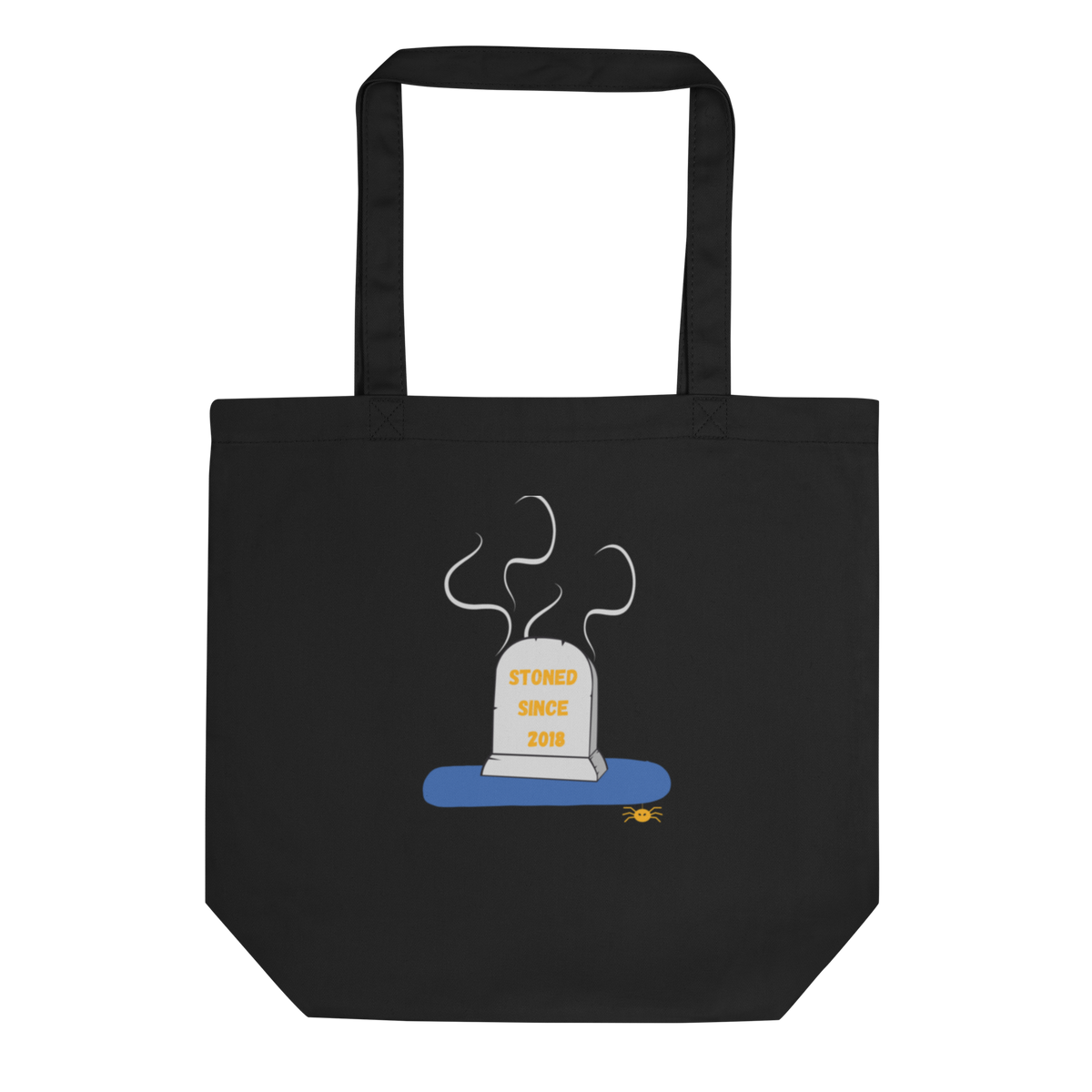 A black canvas tote bag with two top handles, featuring a cartoon graphic of a gray tombstone with yellow text reading 'STONED SINCE 2018' on a blue base, centered on the front.