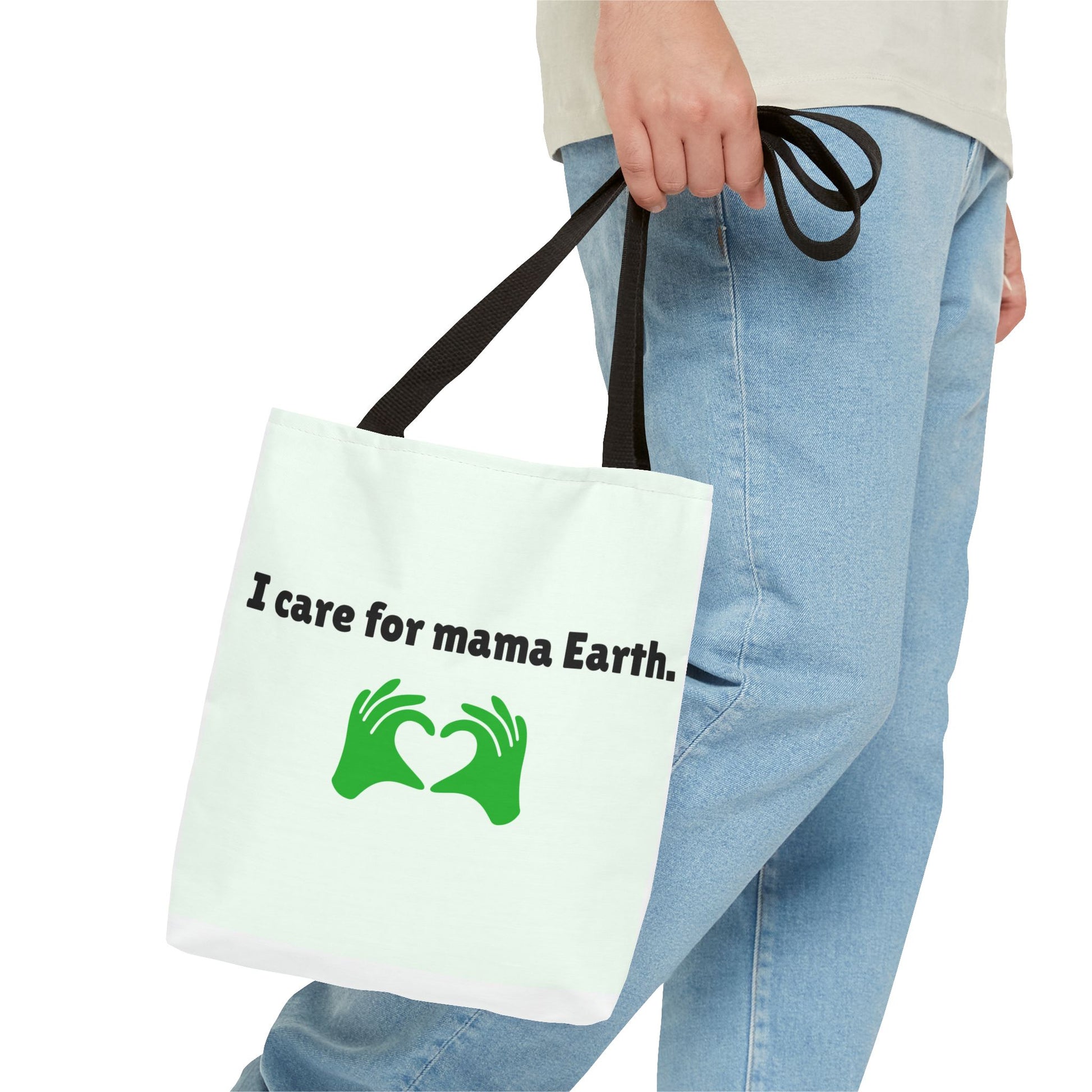 Tote bag with 'I care for mama Earth' text and green graphics held by a person wearing blue jeans.