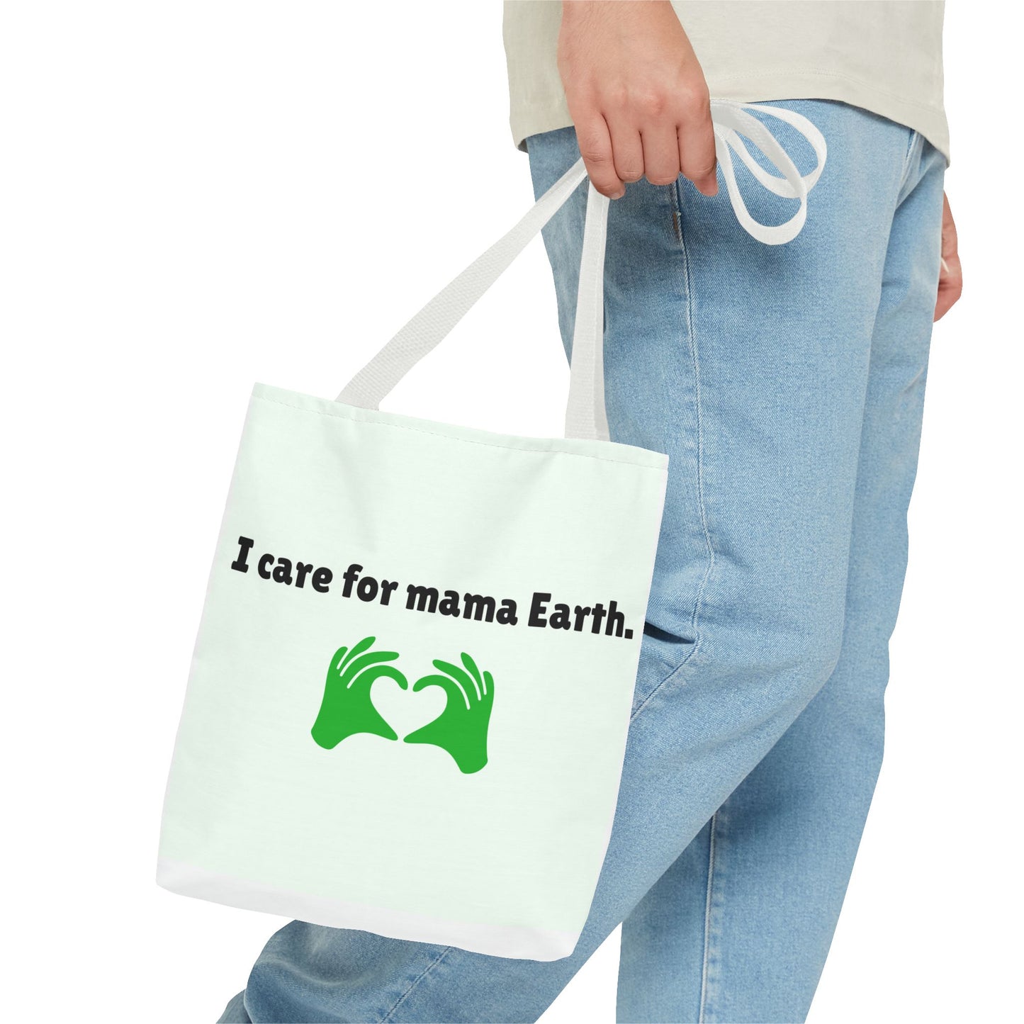 Person holding a tote bag with 'I care for mama Earth' text and green graphics.