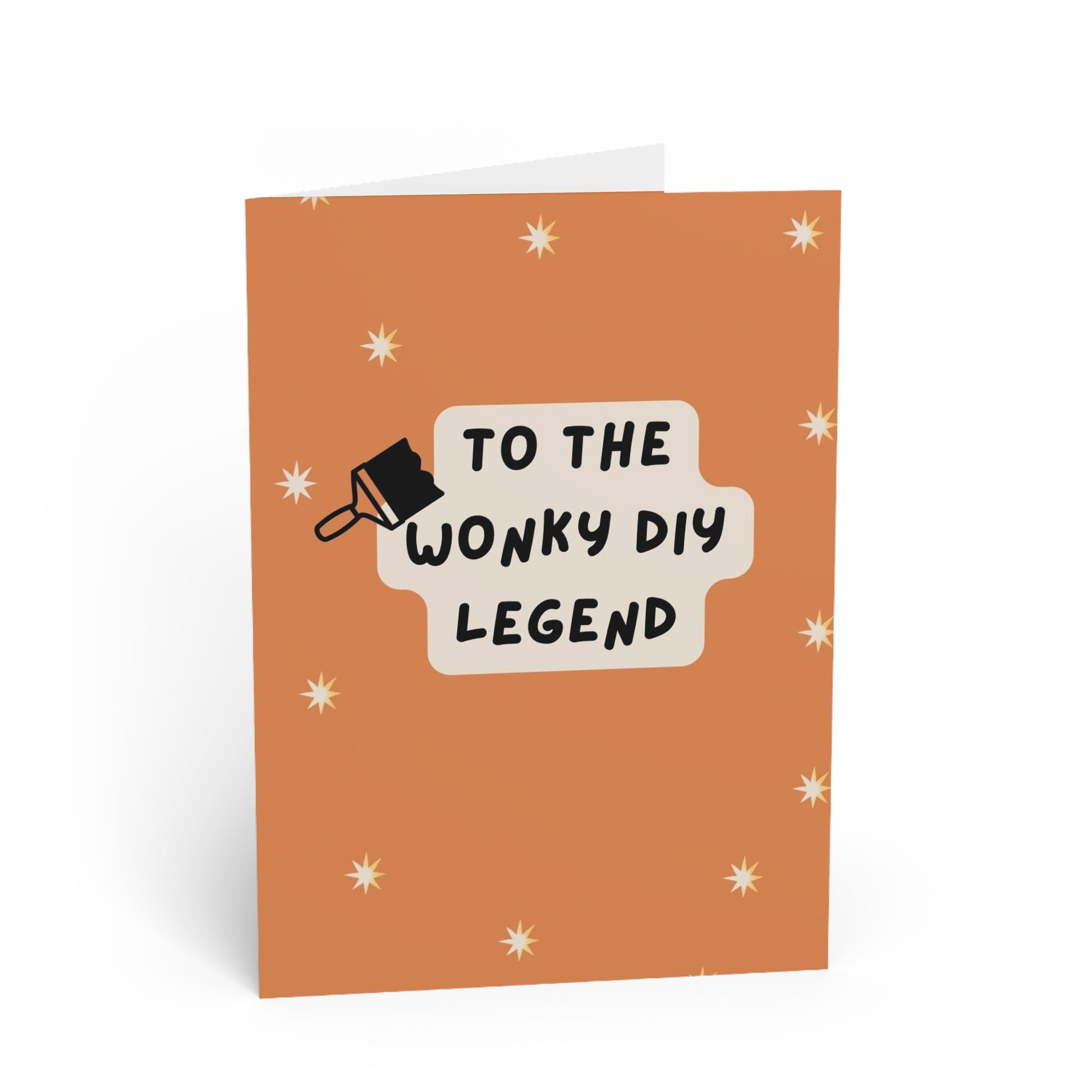 Greeting card with text 'To the wonky DIY legend' on an orange background with star patterns